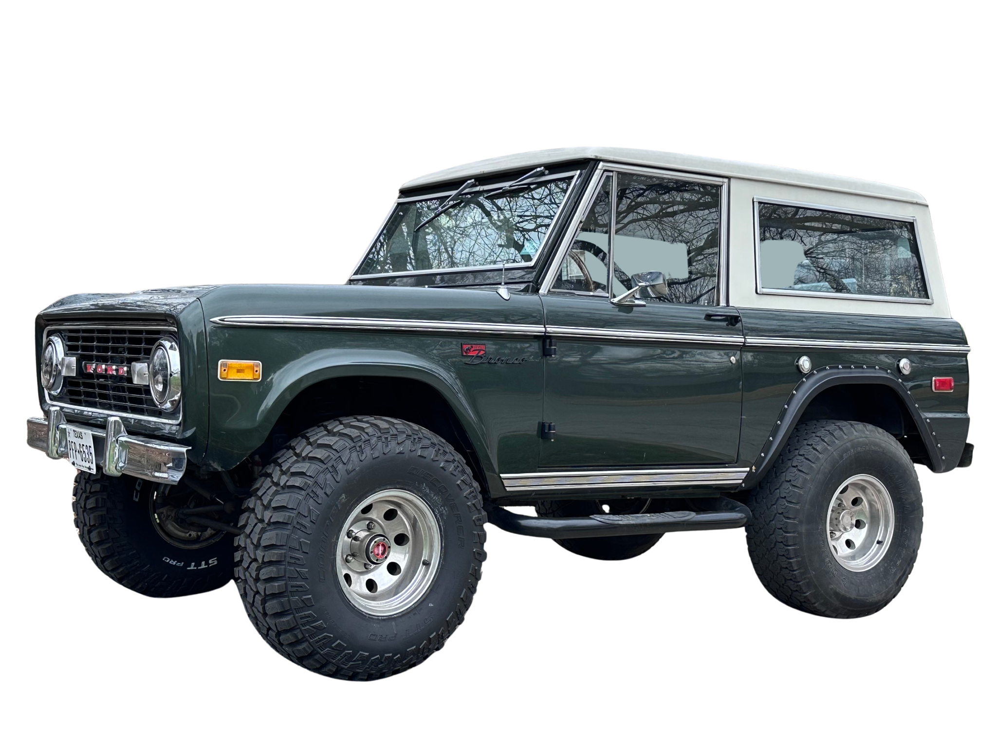 Dark green classic Ford Bronco with a white roof